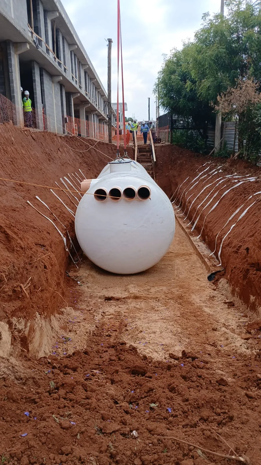 Cisterna Pronta 60,000 L set in the trench at a São Paulo State public school site — rainwater retention